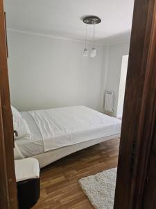 a bedroom with a bed in a white room at Apartament modern cu 2 camere in Vaslui, zona Cartier in Vaslui