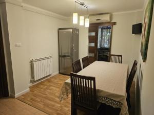 a dining room with a table and a refrigerator at Apartament modern cu 2 camere in Vaslui, zona Cartier in Vaslui