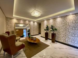 a living room with a table and chairs at Apartamento Majestic Tower in Capão da Canoa