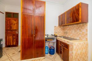a kitchen with wooden cabinets and a counter top at Yunke Homes Comfortable Studio in Bamburi in Mombasa +12 photos