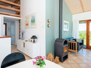 a living room with a fireplace and a couch at 8 person holiday home in Ulfborg-By Traum in Thorsminde