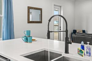 a kitchen with a sink and a faucet at Salty Seabass 4BR Seaside Escape in Port Bolivar +62 photos