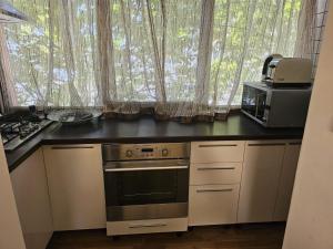 a kitchen with a stove and a microwave at Apartament modern cu 2 camere in Vaslui, zona Cartier in Vaslui
