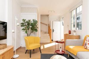 a living room with a yellow chair and a couch at Casa Anik Boutique Home, La laguna in Las Lagunas +47 photos
