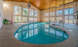 a large swimming pool in a large building at Cozy Retreat awaits w Pool Grill Near Dollywood in Pigeon Forge