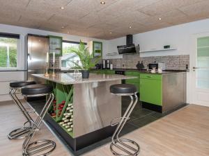 une cuisine avec des armoires vertes et des tabourets de bar dans l'établissement 8 person holiday home in Hemmet, à Hemmet