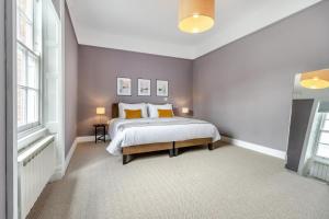 a bedroom with a large bed and two windows at 3 Bed in Cyfronydd oc-e32742 in Llanfair Caereinion