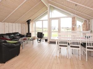 a living room with a table and a couch at 6 person holiday home in Vestervig-By Traum in Vestervig +22 photos