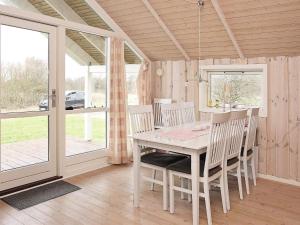 a dining room with a white table and chairs at 5 star holiday home in Vestervig in Vestervig