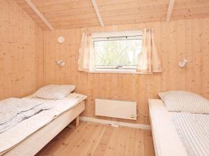 two beds in a room with a window at 5 star holiday home in Vestervig in Vestervig +22 photos
