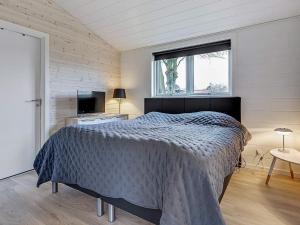 a bedroom with a bed and a window at 5 star holiday home in Hejls in Hejls