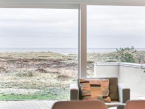 a living room with a view of the beach at 6 person holiday home in Læsø-By Traum in Læsø +16 photos