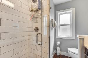 un bagno con doccia, WC e finestra di Ski-InandSki-Out Gemini Lift Access! Home with Hot Tub a Winter Park Altre 25 foto