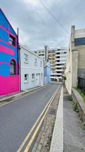 an empty street in a city with buildings at Retro House by the Sea in Hollington