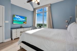 a bedroom with a white bed and a window at 2 Bdrm Penthouse with Billiards in Orlando