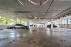 an empty parking lot with two cars parked in it at 2 Bdrm Penthouse with Billiards in Orlando +57 photos