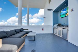 a living room with a couch and a large window at 2 Bdrm Penthouse with Billiards in Orlando