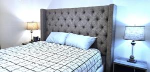 a bedroom with a bed with a large headboard and two lamps at 2 Bedroom, Washer-Dryer, Sleeps 6, lower in Page