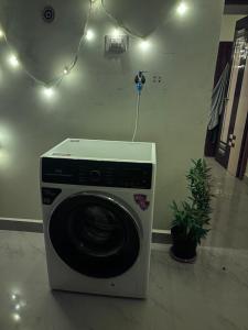 a washing machine sitting in a room with lights at South Goa homestay near Rajbag Beach in Canacona