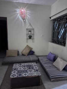 a living room with two couches in a room at South Goa homestay near Rajbag Beach in Canacona