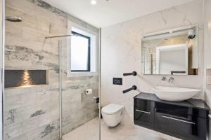a bathroom with a sink and a mirror at Getaway on Galloway - Close to the Lake in Wanaka +20 photos