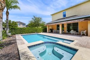a swimming pool in the backyard of a house at Luxury Home With Private Pool And Water Park & Resort Access Near Disney At Encore Resorts Reunion - 240Mn in Kissimmee