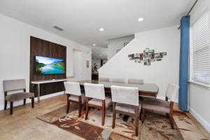 a dining room with a table and chairs at Luxury Home With Private Pool And Water Park & Resort Access Near Disney At Encore Resorts Reunion - 240Mn in Kissimmee +26 photos