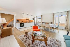 a living room with a couch and a table at ATLAS beautiful 2-Bed Apartment near the Sea in Saint Malo +13 photos