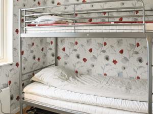 a bedroom with two bunk beds with floral wallpaper at 4 star holiday home in Ljungskile in Ljungskile