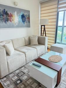 a living room with a white couch and a coffee table at Yara Colombo-a place to unwind in Colombo