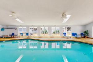 a swimming pool in a room with blue chairs at Wellington Manor 214 in Wells