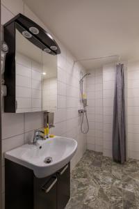 a bathroom with a sink and a shower at Bob W Stockholm Gamla Stan in Stockholm