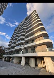 a large apartment building with a tall building at Sweet HOME in Shëngjin