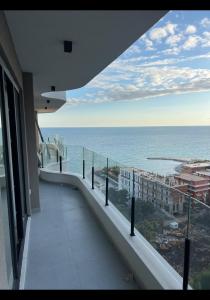 a view of the ocean from the balcony of a building at Sweet HOME in Shëngjin +4 photos