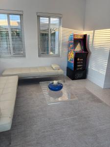 a living room with a couch and a video game at Mid-Century with Outdoor Oasis in Fort Lauderdale