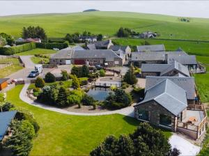 an aerial view of a large house with a yard at 5 Bed House -Sleeps 10- Hot Tub - Garden - Parking in Edinburgh