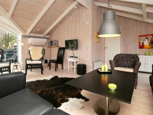 a living room with a black table and chairs at 8 person holiday home in Ålbæk-By Traum in Ålbæk