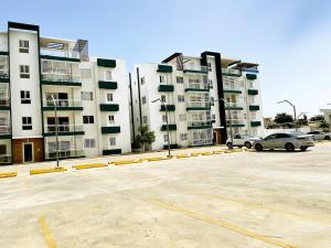 a parking lot in front of a large building at Ideal space for the family in Boca Chica