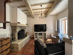 a living room with a couch and a fireplace at Maison des Remparts in Montbrun-des-Corbières
