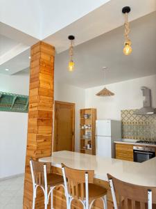 a kitchen with a dining table and chairs at Dar Emna in El Guecheïne