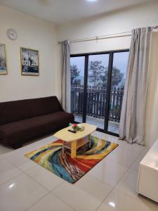 a living room with a couch and a coffee table at Swiss Garden resort residence by Moonlight in Kuantan
