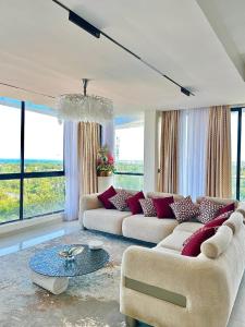 a living room with two couches and a table at Mira Heights in Mombasa