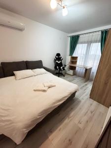 a bedroom with a large bed and a desk at Casa Stefan in Sînmartin +10 photos