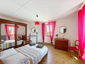 a bedroom with two beds and pink curtains at Ferme Gascone proche Marciac in Bars