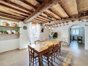 a dining room with a wooden table and chairs at Ferme Gascone proche Marciac in Bars +13 photos