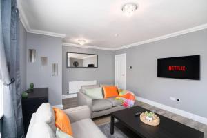 a living room with a couch and a table at 110 Wardlaw Retreat-wifi-parking in Oakley