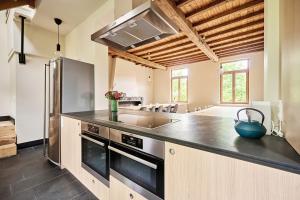 a kitchen with a sink and a refrigerator at Sint-Jacobshoeve 2 in Oudenaarde