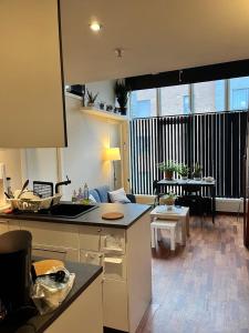 a kitchen and living room with a large window at SimpliCITY in Stavanger