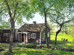 a small house in a field with trees at 4 star holiday home in kode in Kode