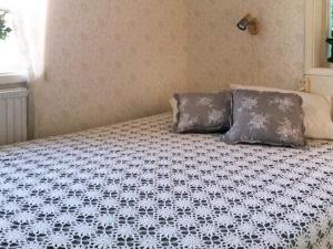 a bed with two pillows on it in a bedroom at 4 star holiday home in kode in Kode